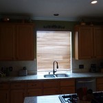 Stainless steel kitchen sink w/window & travertine backsplash