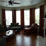 Living Room has tall windows, built in bookcases, & wired for surround sound
